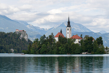 view of bled lake the church of mary assumption and the mountains