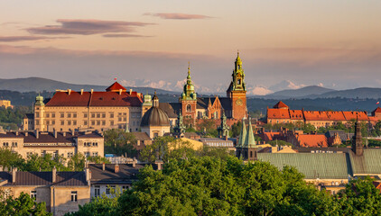 Wawel castle during colorful sunset with snowy Tatra mountains in the background, Krakow, Poland - 553321689