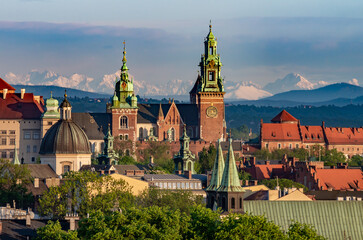 Wawel castle during colorful sunset with snowy Tatra mountains in the background, Krakow, Poland - 553321699
