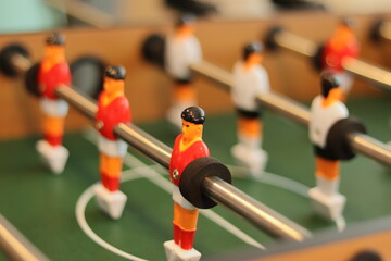 Close-up of a table football table, with the football players bolted to the metal bars. Horizontal...