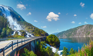 Summer mountain Langfossen waterfall on slope (Etne, Norway).