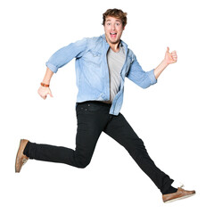 Jumping man happy excited. Funny portrait on young casual male model in humorous jump on isolated...