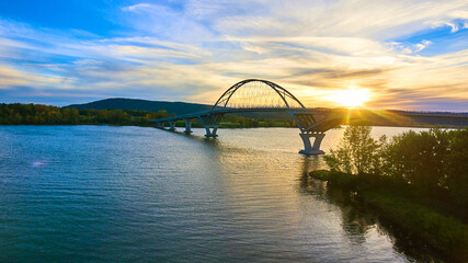 Fototapeta premium Bridge at sunset with blue skies over water connecting New York to Vermont
