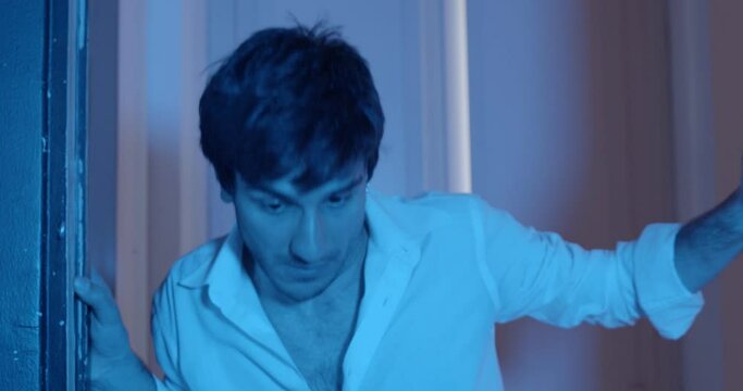 problems, addiction - tipsy young man walks indoors staggering