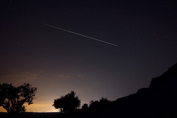 Picturesque view of starry sky at night over hill