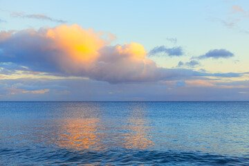 Colorful clouds over the ocean . Twilight reflection in the seawater