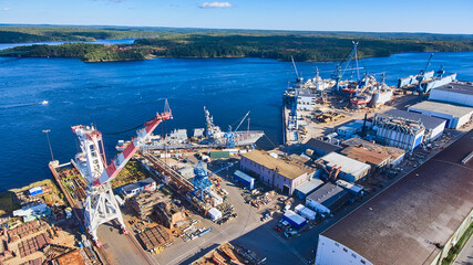 Shipyard on Maine river from above as many large ships are being built