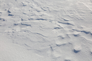 A sheet of snow is blown by the wind