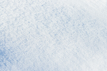 Natural snow texture. Smooth surface of clean fresh snow. Snowy ground. Winter background with snow patterns. Perfect for Christmas and New Year design. Closeup top view.