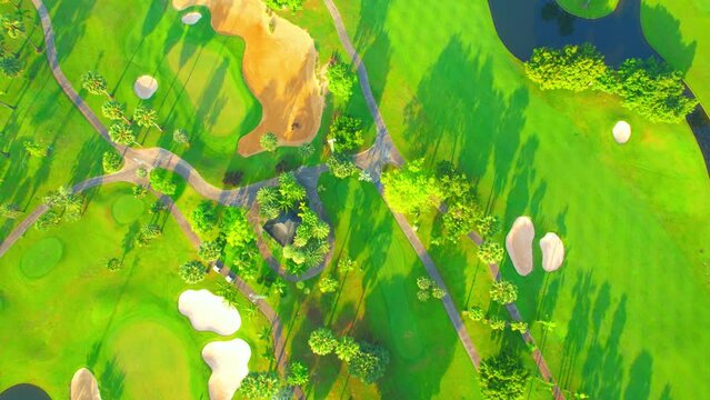 Aerial view over golf field landscape during sunrise. meditative leisure activities. Hobby and sports concepts. summer day. green background. drone 4K

