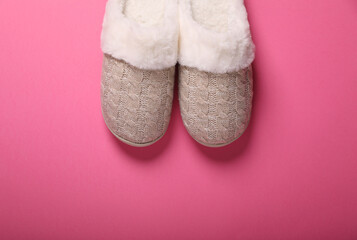 Pair of beautiful soft slippers on pink background, top view. Space for text