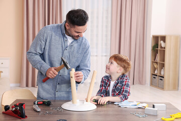 Father teaching son how to make stool at home. Repair work