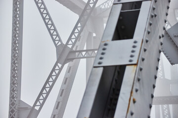 Foggy morning detail of steel beams on bridge