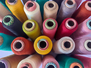 View of Multicolor sewing threads with white background 