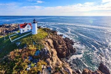 Aerial in Maine lighthouse with stunning view of ocean waves