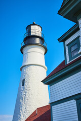 Detail of large white brick lighthouse from below