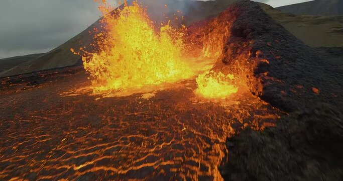 Cinematic slow motion Fpv drone shot flying really near a erupting Volcano, spewing magma cone