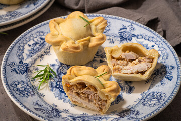 Tasty homemade baked chicken pies on plate