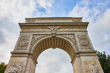 Fototapeta na wymiar Top of Washington Square Park limestone arch looking up towards sky