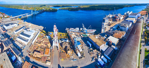 Panorama aerial over shipyard making military ships on river of Maine