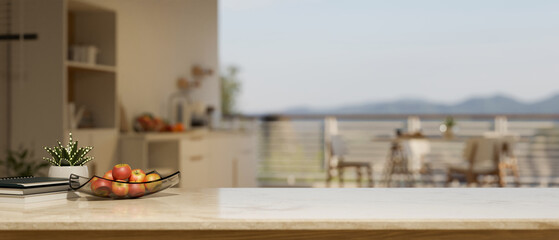 Copy space on marble kitchen tabletop with apple tray and decor over blurred kitchen with dining table