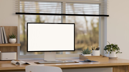 PC desktop computer mockup is on wooden table with decor against the window. home office