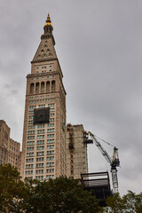 New York City building with front clock covered for construction