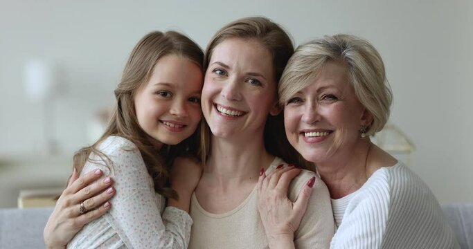 Close Up Portrait Of Diverse Ages And Generations Women, Understanding, Heredity. Beautiful Happy Multigenerational Family Spend Time Together Showing Love, Share Warmth, Cuddling, Staring At Camera