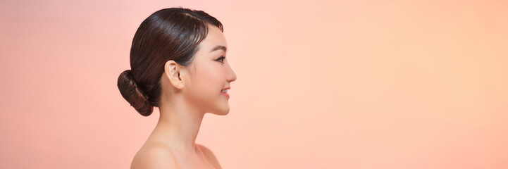 Side view of Beautiful Asian woman looking at camera smile with clean and fresh skin