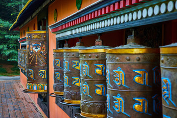 Large ornate prayer wheels at Tibetan Mongolian Buddhist shrine