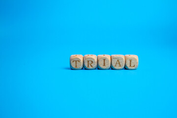 small wooden cube with the word trial. the concept of a trial or trial period