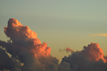 White fluffy cumulonimbus clouds forming before thunderstorm on evening sky. Changing stormy...