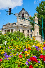 Fototapeta na wymiar Bloomington Indiana courthouse with blurry colorful summer flowers in foreground