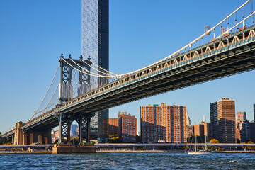 Obraz premium New York City famous Manhattan Bridge from Brooklyn looking at city with ship