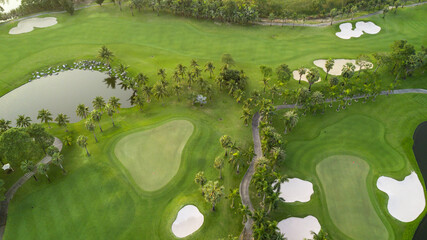 Aerial view of green golf course and putting green, Aerial view of green grass and coconut palm...