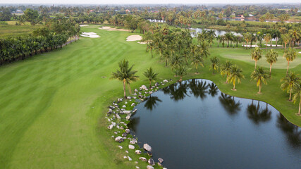 Aerial view of green golf course and putting green, Aerial view of green grass and coconut palm...