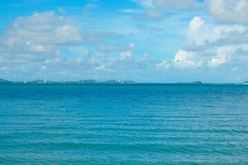 Tropical sea beach wave blue sky with fluffy cloud