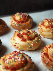 festive candied fruit bread rolls with rainbow nonpareil sprinkles