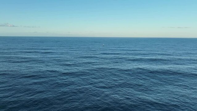Aerial wide shot of single lone Sailing Yacht in ocean, at full sail. Shot off Gold Coast Australia