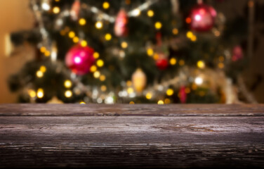 Wood table and defocused Christmas tree in the background