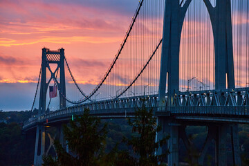 Beautiful Mid-Hudson bridge in New York during sunrise with American Flag