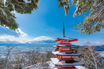 The Chureito Pagoda with the background of Mount Fuji during winter with cloud hat is cover