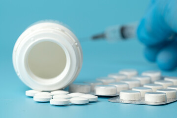 Many medical pills on a blue background. Drug for the treatment of diseases