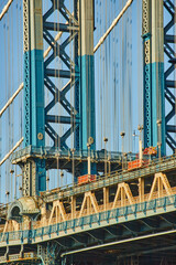 Detail of beautiful Manhattan bridge section in sun with blue and white paint from Brooklyn