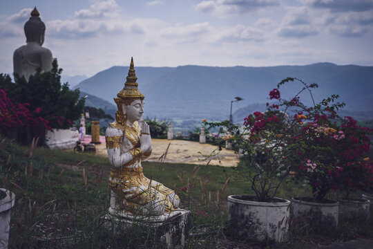 beautiful white stucco Buddha statue  enshrined on the hillside  It is a place of meditation called Wat Sutesuan, Nam Nao District, Thailand.