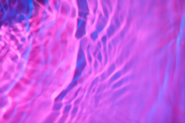 Texture of clean water on color background