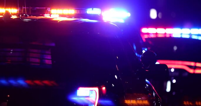 Night time view of a police unit responding to the scene of an emergency.