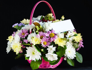 flowers in the basket on dark background