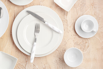 Table setting with white plates on grunge background
