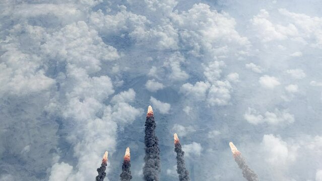 Meteors asteroids or missiles burning over clouds
Aerial view over burning meteors or rockets flying over the clouds, Cinematic view,2022

